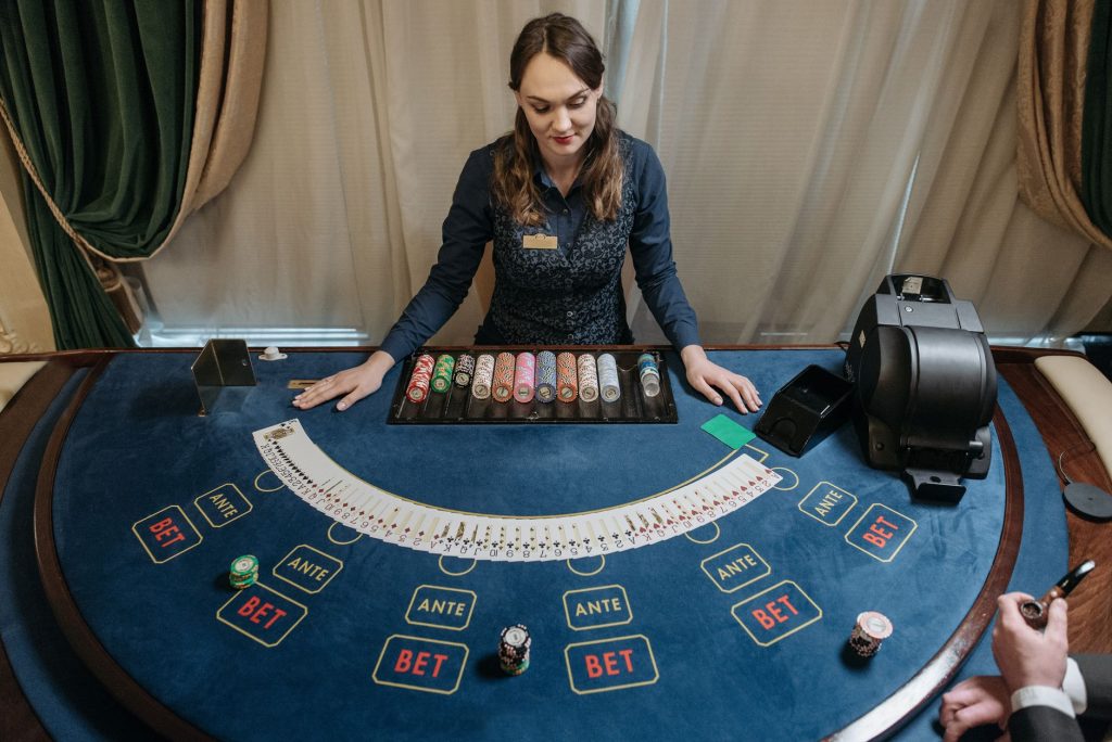 Professional female casino dealer managing a gaming table with chips and cards in a luxurious setting. — 5 Best Advantages Of