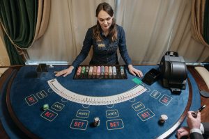 Professional female casino dealer managing a gaming table with chips and cards in a luxurious setting. — 5 Best Advantages Of