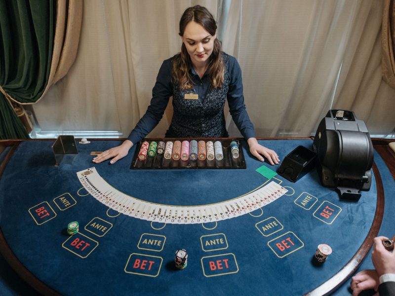 Professional female casino dealer managing a gaming table with chips and cards in a luxurious setting. — 5 Best Advantages Of