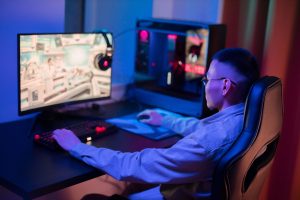 A young man intensely gaming on a computer at home, showcasing a modern gaming setup. — 5 Tips and Methods for Online Soccer