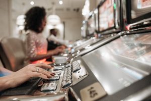 Close-up view of hands playing slot machines in a casino setting. — Could it be okay to select a web-based football betting s