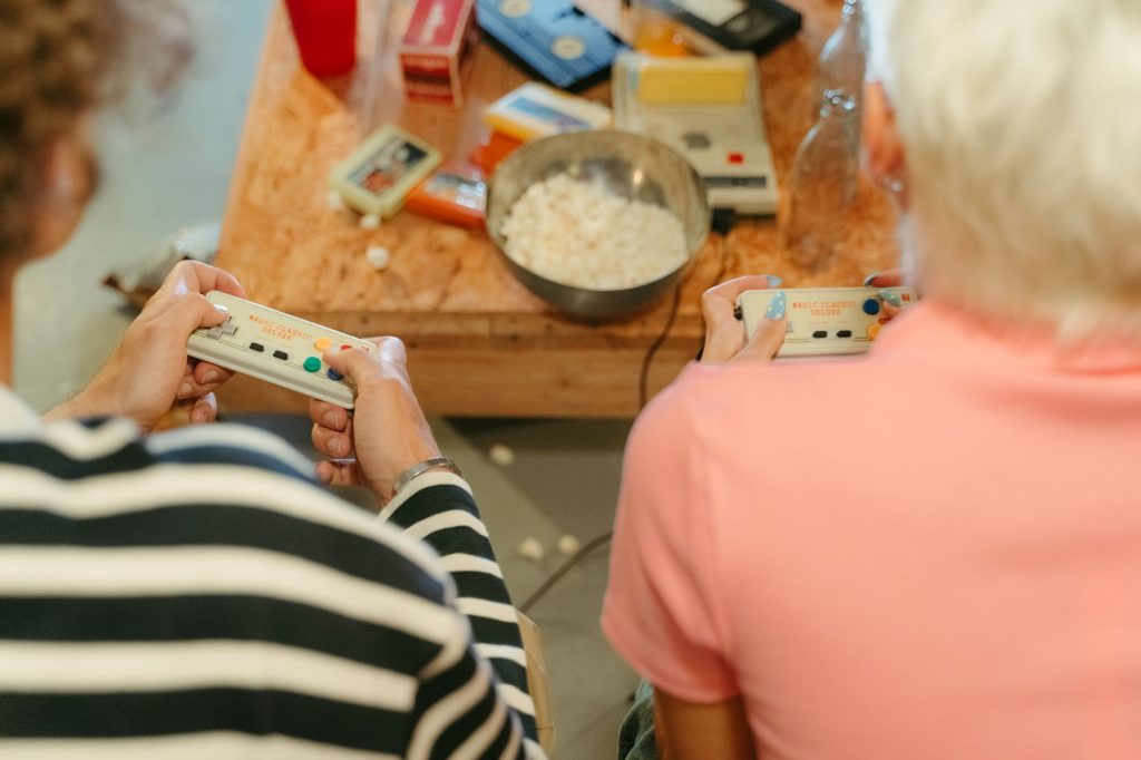 Two teenagers play video games together with snacks, creating a fun indoor atmosphere. — Ethical Implications of the Lottery:
