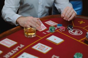 Intense poker game with cards and chips on a red casino table, creating a thrilling atmosphere. — Gain Complete Understanding