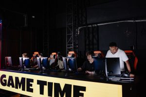 Esports team engaged in competitive gaming session indoors, showcasing teamwork and concentration. — mpo007 helps you stay in