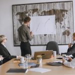 Group of business professionals discussing strategies with growth chart in conference room. — PHFUN: Gaming Excellence from C