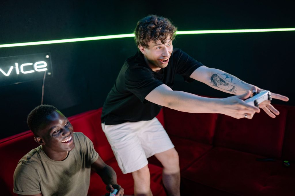 Two young men having fun playing video games in a cozy indoor setting. — Sekabet Login: Privacy and Data Protection