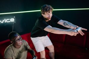 Two young men having fun playing video games in a cozy indoor setting. — Sekabet Login: Privacy and Data Protection