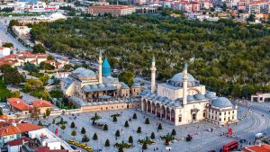Vibrant aerial view of the iconic Mevlana Museum located in Konya, Türkiye, surrounded by lush greenery. — Step Into the Worl