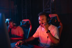 Two gamers immersed in an esports tournament, focused with headsets and keyboards. — Feel the Rush of High-Stakes Act